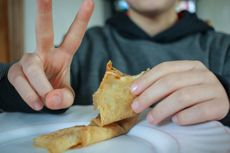 young boy eating a delicious crepe in Spainの写真素材