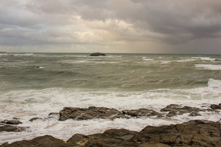 The Cantabrian sea is rough under a cloudy sky and on a windy dayの写真素材
