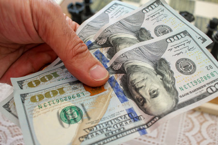 three one hundred dollar bills in my left hand
