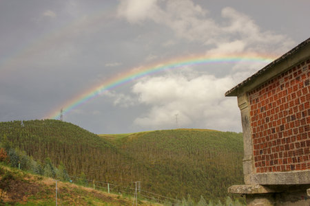 rainbow over the mountains in Galicia, Spain, at an autumn sunsetの写真素材