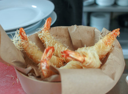 tempura-style prawns ready to be eaten in a restaurantの写真素材