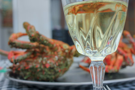 two spider crabs and a cup of white wine for lunch at homeの写真素材