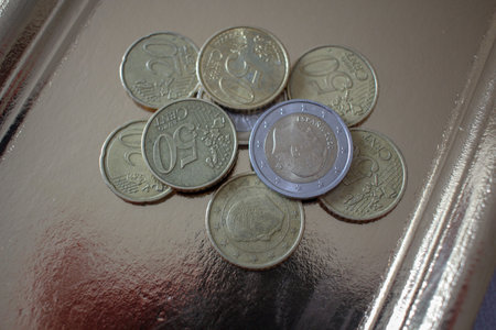 several euro coins on a golden tray