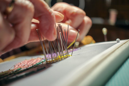 an elderly woman making a flower with thread at homeの写真素材