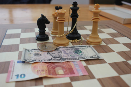 bank notes, fiat money, bitcoin and gold compete for a place on the chess board of the investor