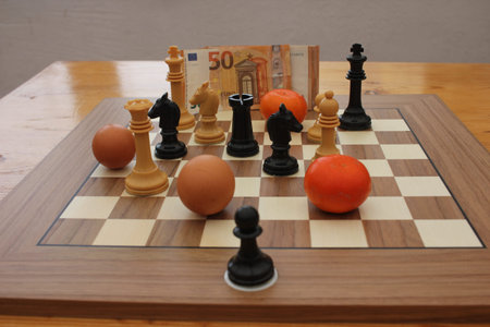 A chessboard becomes a metaphor for the economy, where food items and banknotes reflect the growing...