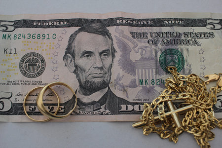Concept of selling gold jewelry or valuables to get immediate cash during economic changes.