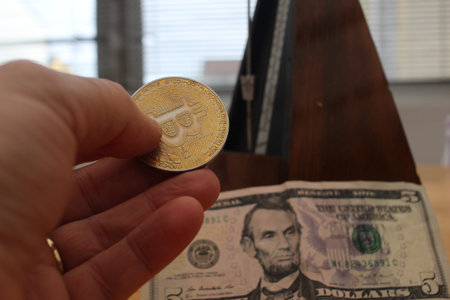 Time, Crypto, and Currency: A Metronome with Bitcoin and Dollarsの写真素材