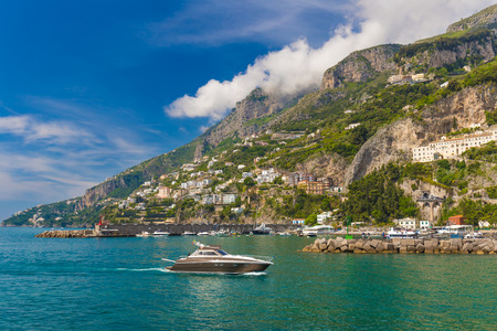 Amazing generic view on Amalfi coast from town of Amalfi, with small boat approaching, Campania region, Italyのeditorial素材