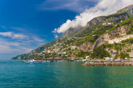 Amazing generic view on Amalfi coast from town of Amalfi, with small boat approaching, Campania region, Italyの写真素材