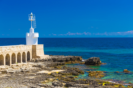 Little lighthouse of Otranto town, beautiful sea view, Salento peninsula, Puglia region, Italyの写真素材