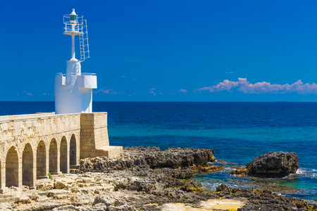 Little lighthouse of Otranto town, beautiful sea view, Salento peninsula, Puglia region, Italyの写真素材