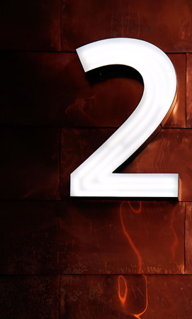 White number 2 on a bronce background