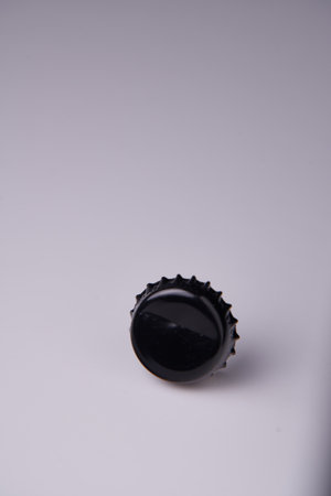 black dented bottle cap on light backgroundの写真素材