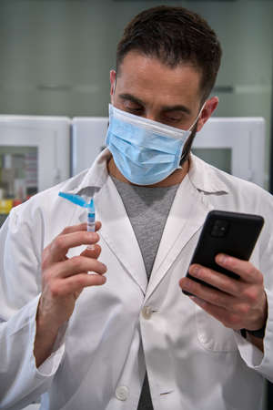 close view of a hand with a vaccine syringe