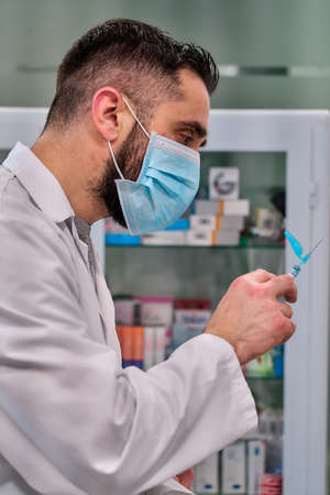 close view of a hand with a vaccine syringe