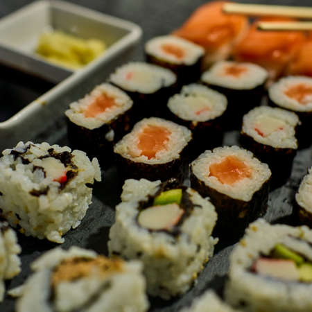Black slate tray with assorted sushi piecesの写真素材