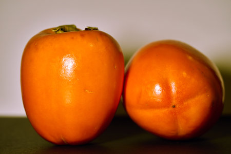 Two ripe persimmons for a healthy mealの写真素材
