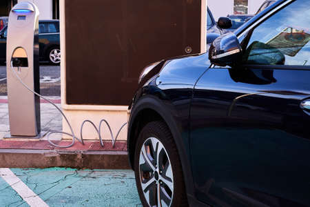 Electric vehicle at the time of charging connected to charging station.の写真素材