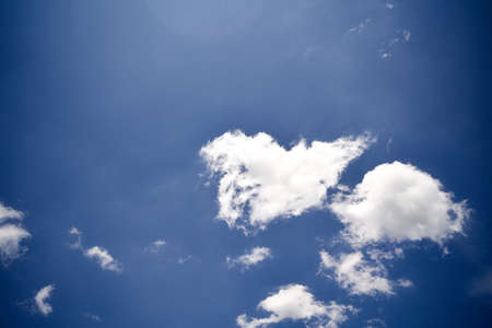 Dramatic sky with dark clouds and a small light illuminating a white cloud. High quality photo