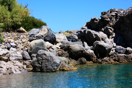 Cretan wild sea coastline with a blue skyの写真素材