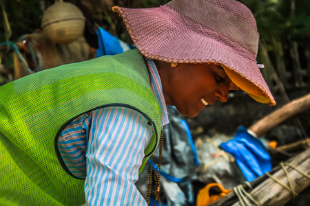 Unknown woman cleaning the beach of Palolem in Goa India October 25-2017 on the morningのeditorial素材