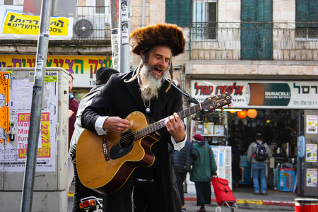 Jerusalem Israel February 16-2018 closeup of a street musician sing and play guitar at the entrance of Mahane Yehuda market in Jerusalem on the morningのeditorial素材