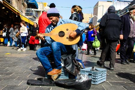 Jerusalem Israel February 16-2018 closeup of a street musician sing and play guitar at the entrance of Mahane Yehuda market in Jerusalem on the morningのeditorial素材