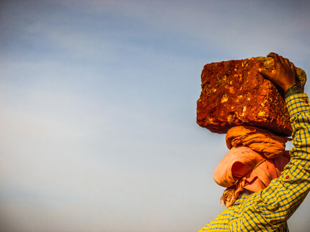 Unknowns women workers carrying stone on the head in Gokarna beach Karnataka India December 03-2017 on the morningのeditorial素材