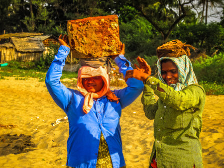 Unknowns women workers carrying stone on the head in Gokarna beach Karnataka India December 03-2017 on the morningのeditorial素材