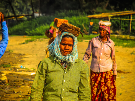 Unknowns women workers carrying stone on the head in Gokarna beach Karnataka India December 03-2017 on the morningのeditorial素材