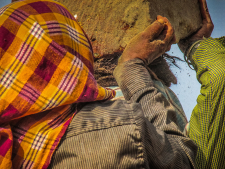 Unknowns women workers carrying stone on the head in Gokarna beach Karnataka India December 03-2017 on the morningのeditorial素材