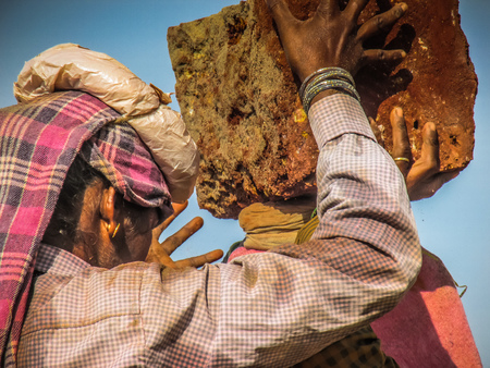 Unknowns women workers carrying stone on the head in Gokarna beach Karnataka India December 03-2017 on the morningのeditorial素材