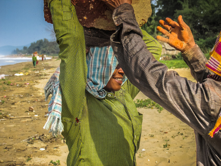 Unknowns women workers carrying stone on the head in Gokarna beach Karnataka India December 03-2017 on the morningのeditorial素材