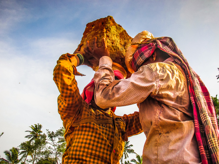 Unknowns women workers carrying stone on the head in Gokarna beach Karnataka India December 03-2017 on the morningのeditorial素材