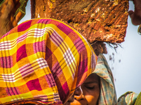 Unknowns women workers carrying stone on the head in Gokarna beach Karnataka India December 03-2017 on the morningのeditorial素材