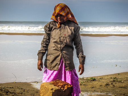 Unknowns women workers carrying stone on the head in Gokarna beach Karnataka India December 03-2017 on the morningのeditorial素材