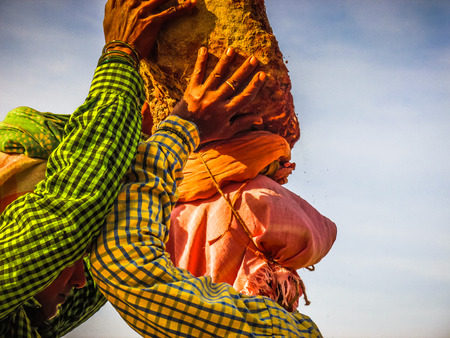 Unknowns women workers carrying stone on the head in Gokarna beach Karnataka India December 03-2017 on the morningのeditorial素材