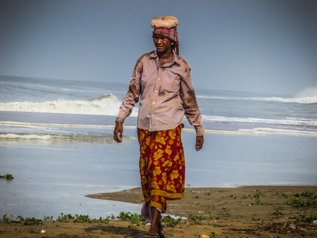 Unknowns women workers carrying stone on the head in Gokarna beach Karnataka India December 03-2017 on the morningのeditorial素材