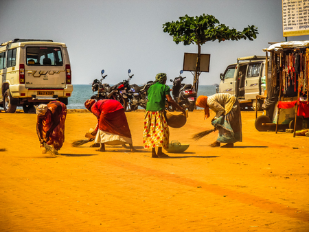 Unknown woman cleaning the street of Palolem in Goa India October 25-2017 on the morningのeditorial素材