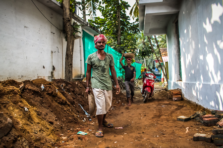 Unknown worker building a street sidewalk in Palolem Goa India October 28-2017 morningのeditorial素材