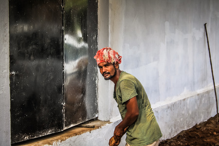 Unknown worker building a street sidewalk in Palolem Goa India October 28-2017 morningのeditorial素材