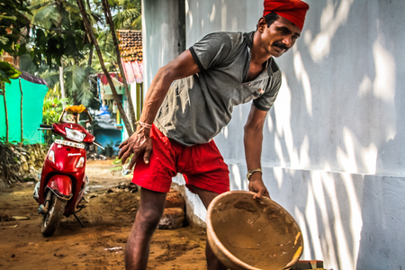 Unknown worker building a street sidewalk in Palolem Goa India October 28-2017 morningのeditorial素材