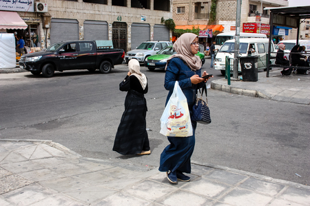 Aqaba Jordan March 27, 2018 Unknown people walking in the street of Aqaba noonのeditorial素材