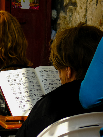 Unknown woman praying front the Western Wall at the old city of Jerusalem on afternoonの写真素材