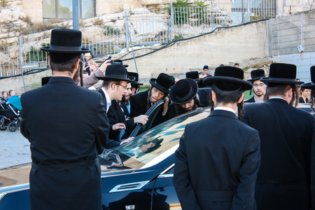 Jerusalem Israel May 14, 2018 unknown religious people accompanying the Chief Rabbi got his car from the Western Wall Square in Jerusalem in the late afternoonのeditorial素材