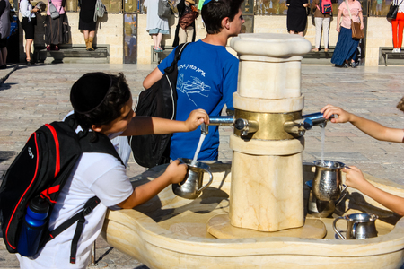 Jerusalem Israel May 14, 2018 unknown kids in front of the public fountain on the Western Wall Square in Jerusalemのeditorial素材