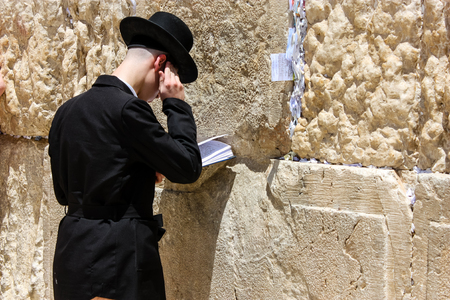 Jerusalem Israel May 21, 2018 View of an unknown religious Orthodox Jew praying in front of the western wall of the old city of Jerusalemのeditorial素材