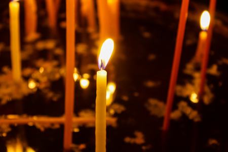 Lighting candles in the Church of the Holy Sepulchre in the Old City of Jerusalemの写真素材