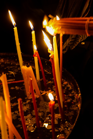 Lighting candles in the Church of the Holy Sepulchre in the Old City of Jerusalemの写真素材